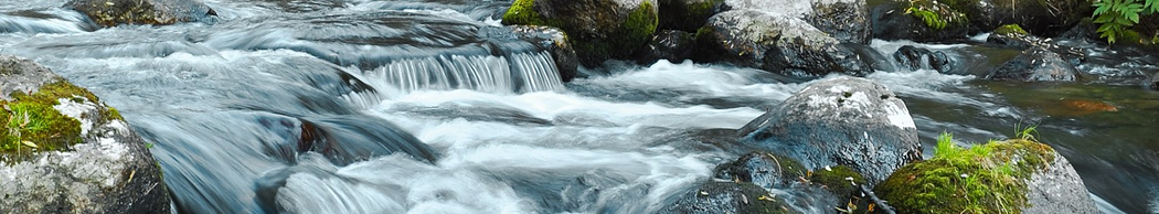 clear stream of water tumbling over rocks
