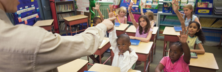 teacher in front of classroom of young students