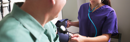 health care worker taking blood pressure