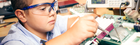 very young boy working on a science project